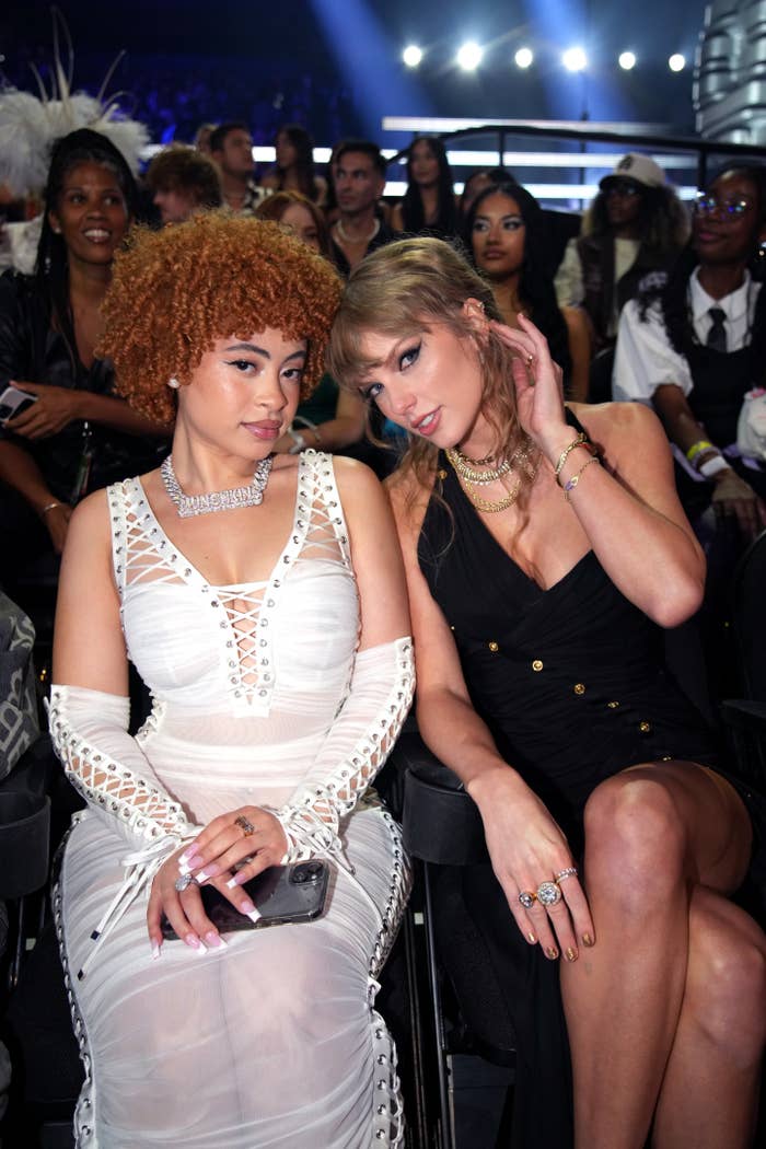 Ice Spice and Taylor Swift are seated at an event