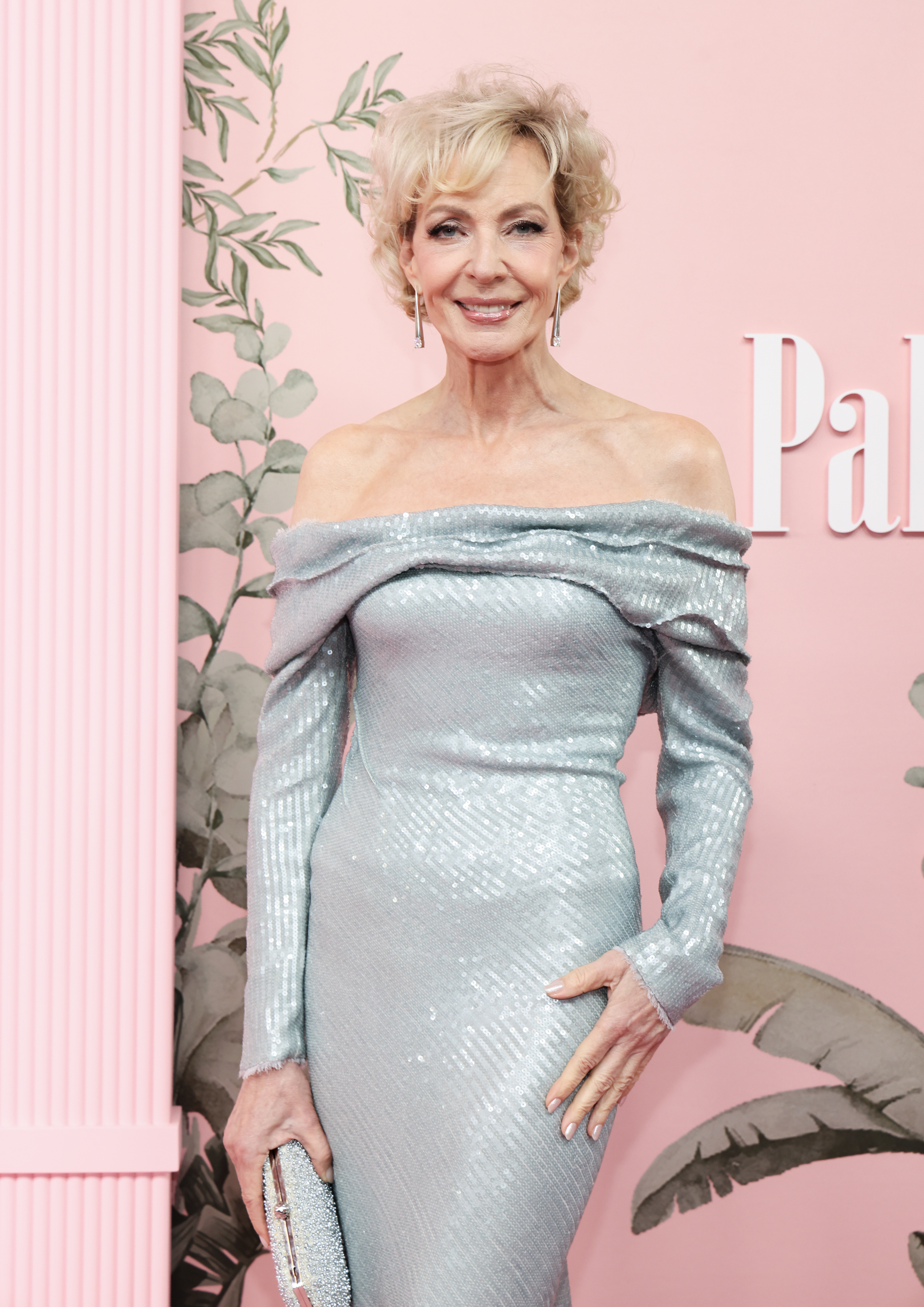 Allison Janney on a red carpet wearing an off-the-shoulder, shimmering gown