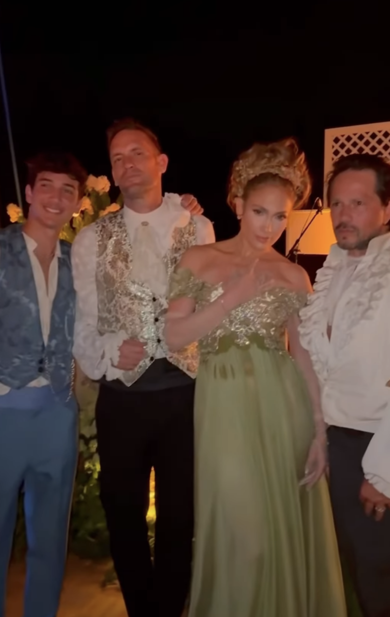 J.Lo posing for a picture with three other people