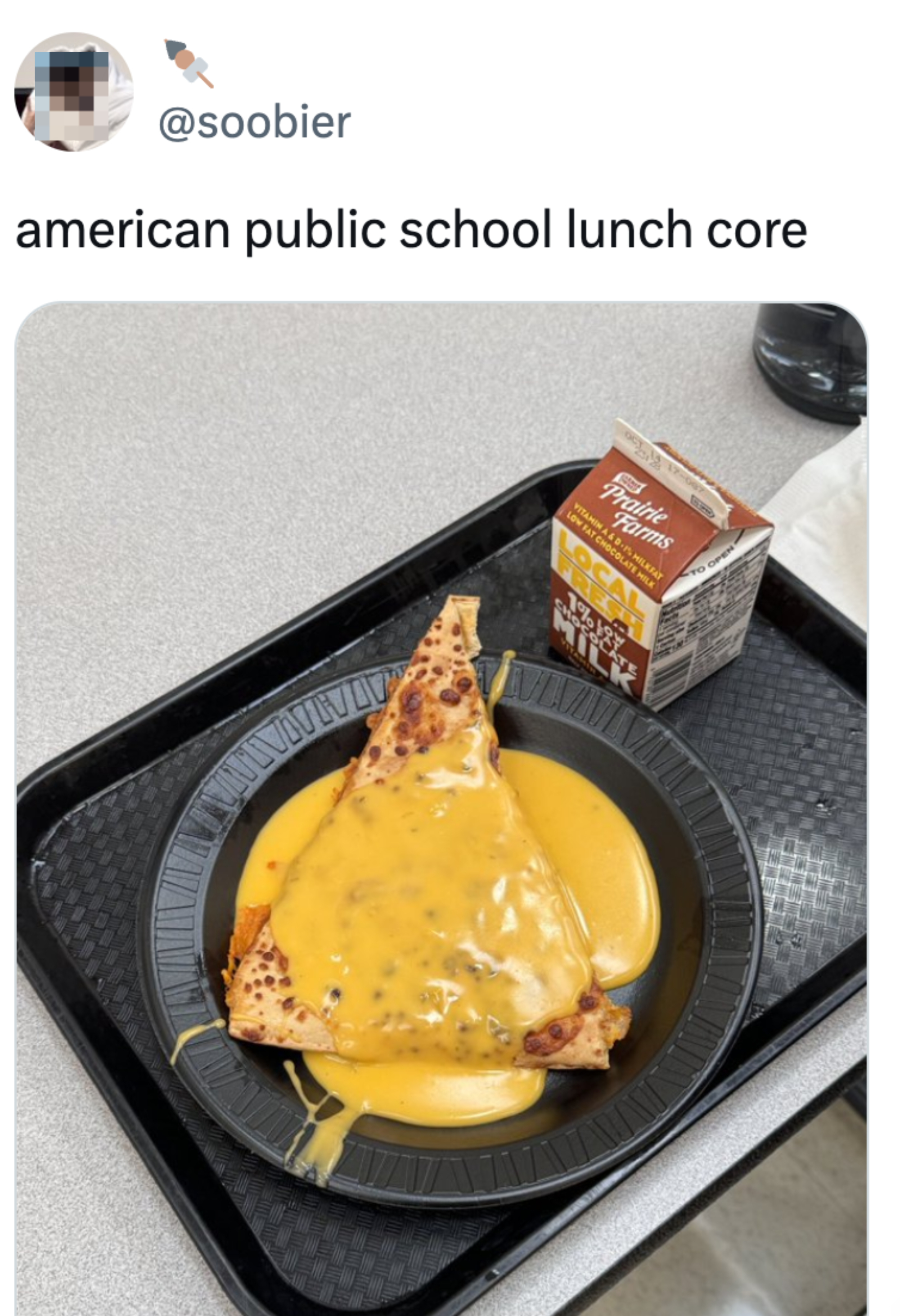 A slice of pizza covered in melted cheese with a chocolate milk carton on a black tray. The Twitter handle "@soobier" and the text "american public school lunch core" are displayed above