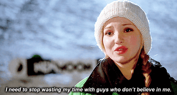 Dove Cameron wears a warm hat and scarf, saying, "I need to stop wasting my time with guys who don’t believe in me."