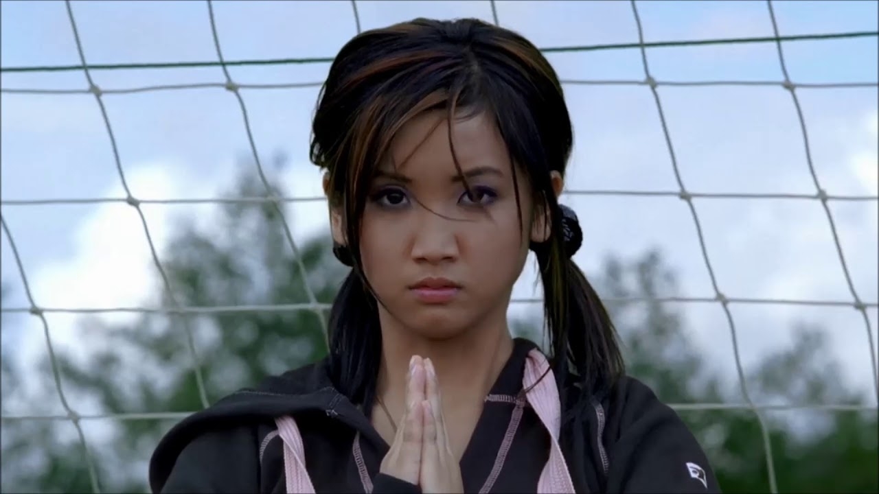 Brenda Song as Wendy Wu with a serious expression, standing in front of a soccer net in the movie "Wendy Wu: Homecoming Warrior"