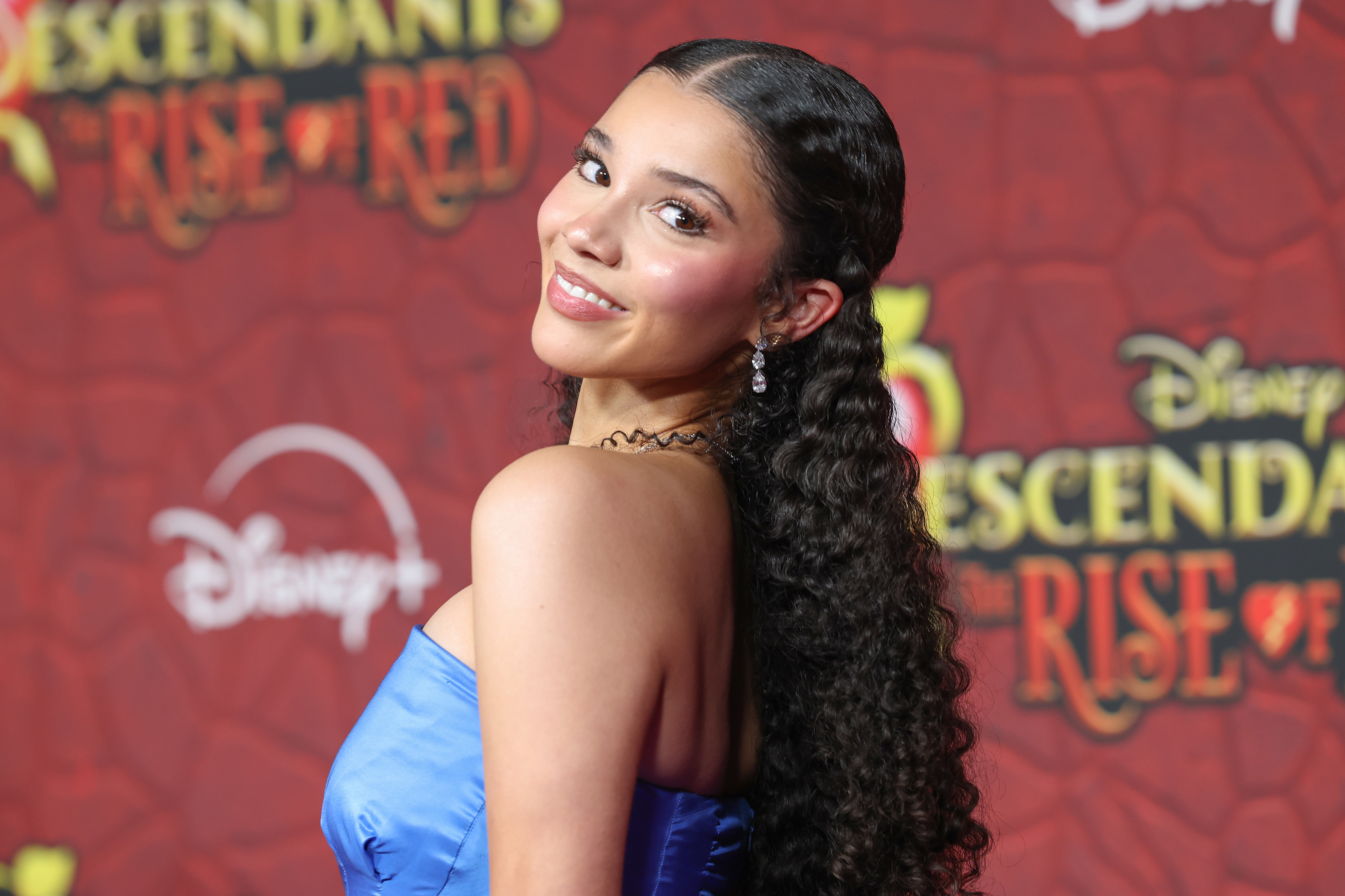 Malia Baker on the red carpet for "Descendants: The Rise of Red" in a blue strapless gown