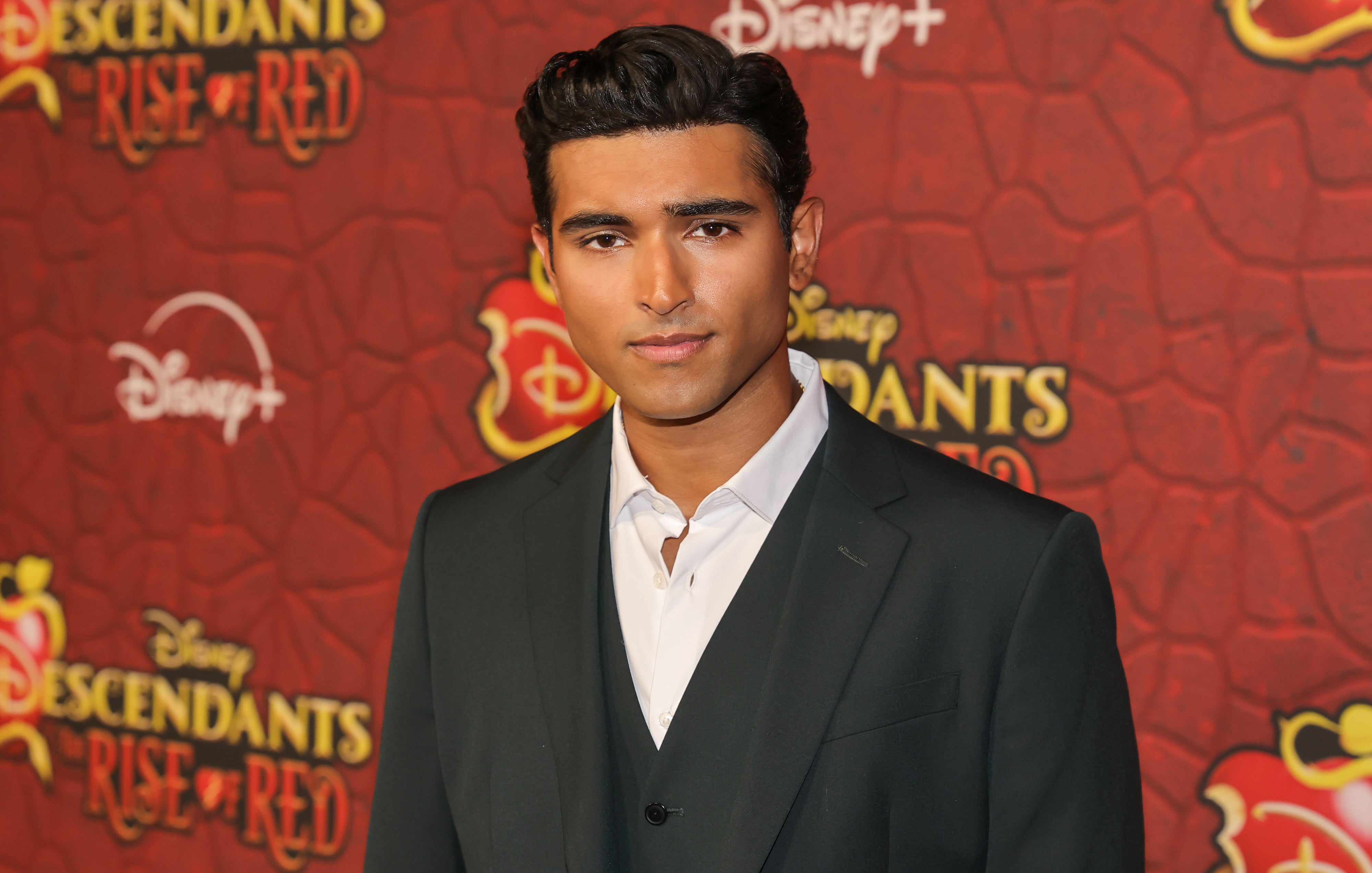 Kabir Bery on the red carpet for "Descendants: The Rise of Red" in a suit