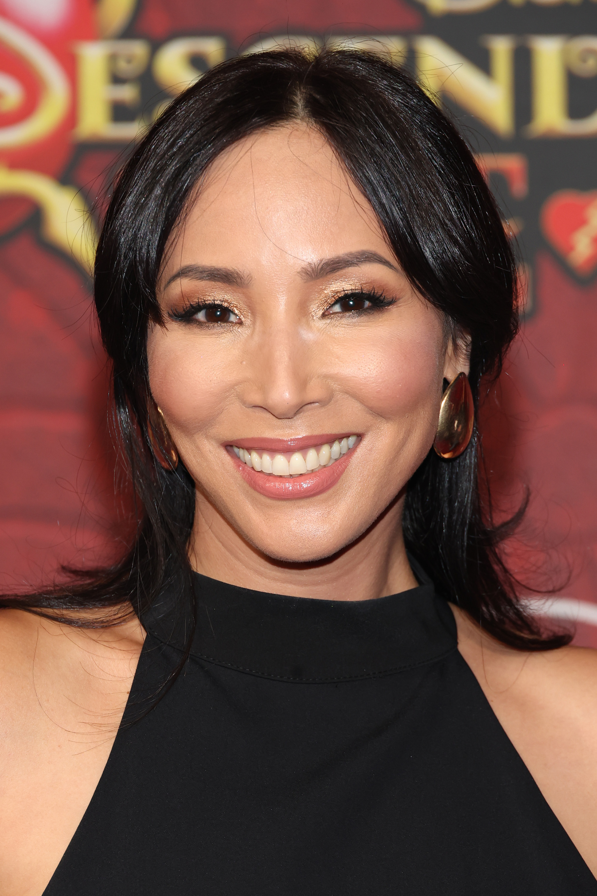 Julee Cerda on the red carpet for "Descendants: The Rise of Red" in a black outfit