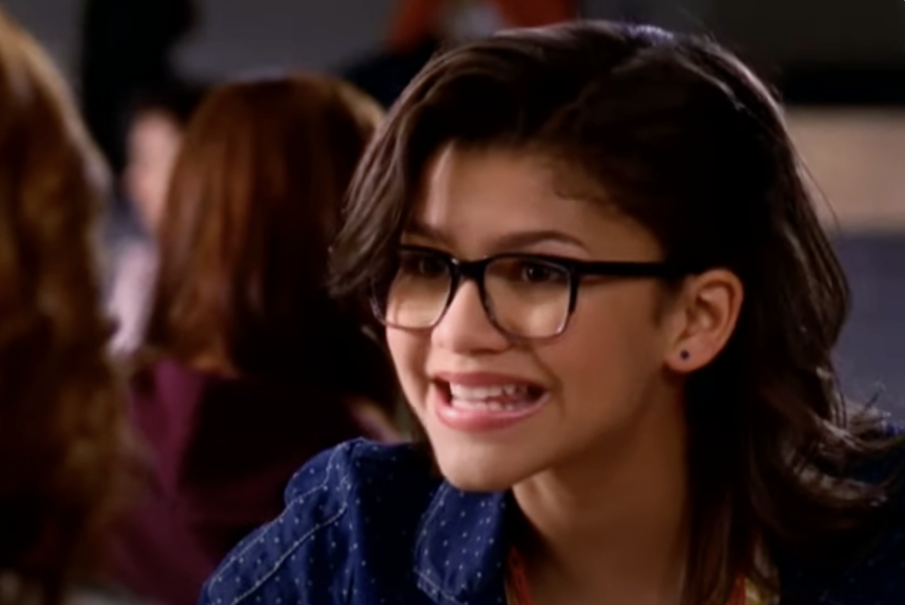 Zendaya smiles and wears glasses in a scene from "Shake It Up."