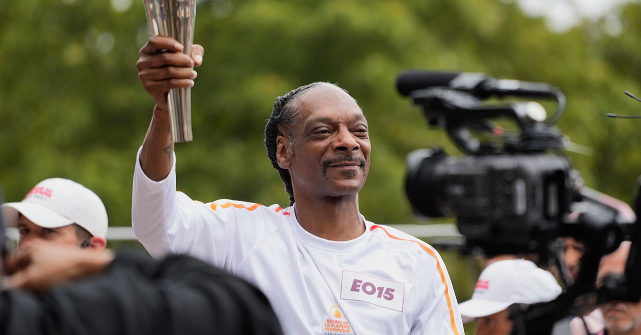 Snoop Dogg Carries Olympic Torch Through Paris, Stops to Dance to 