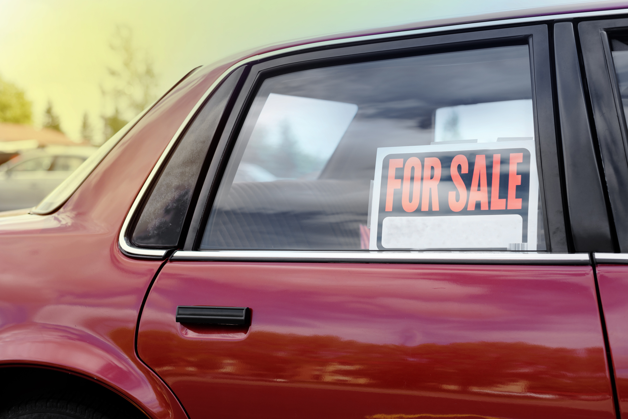 Side view of a car with a &quot;For Sale&quot; sign in the window. Suitable for an article on selling a car for extra income