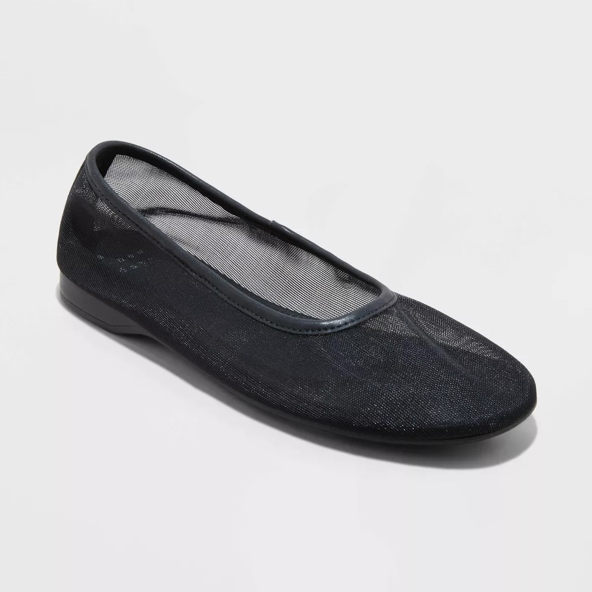 A single black ballet flat shoe with a mesh upper design displayed against a plain background