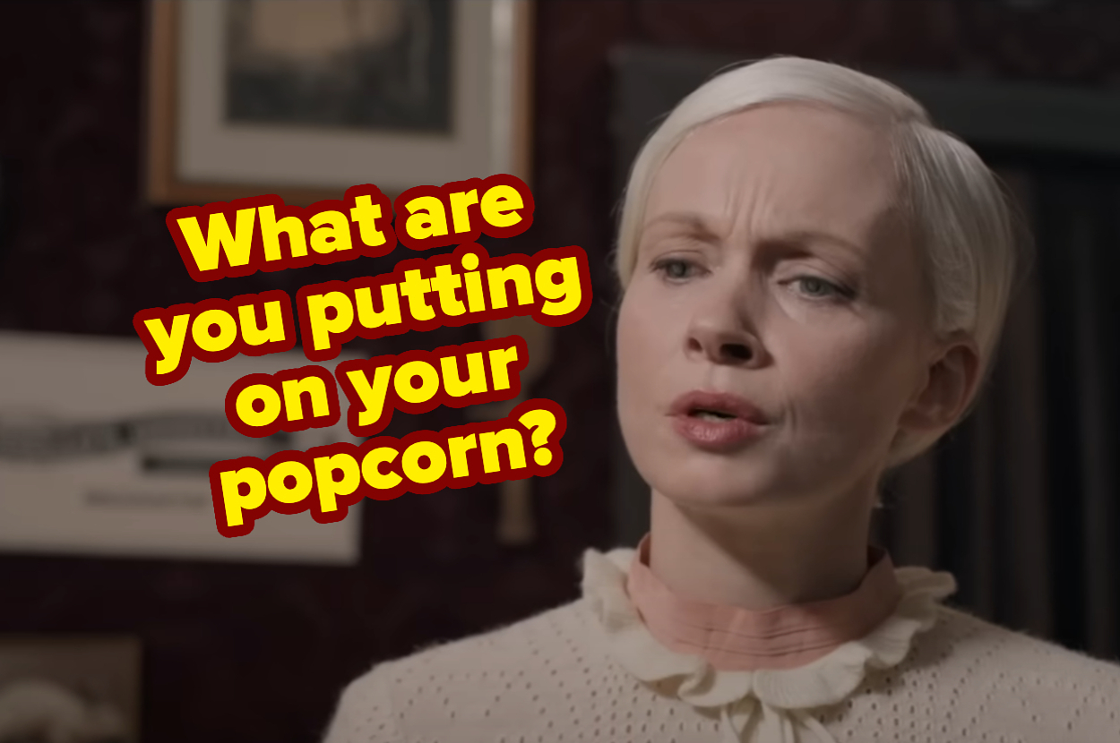 A person with short light-colored hair wearing a high-collared blouse asks, "What are you putting on your popcorn?"