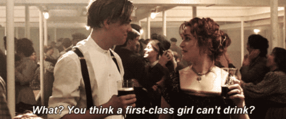 Leonardo DiCaprio and Kate Winslet in a scene from Titanic. Caption: "What? You think a first-class girl can't drink?"
