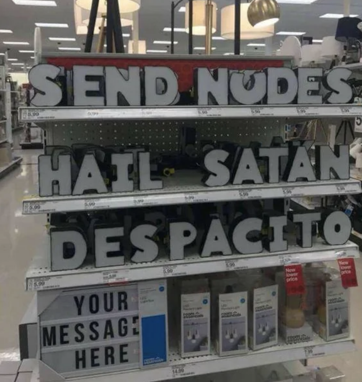 Store shelf with customizable letter signs displaying the phrases "SEND NUDES", "HAIL SATAN", and "DESPACITO". Blank section for custom message