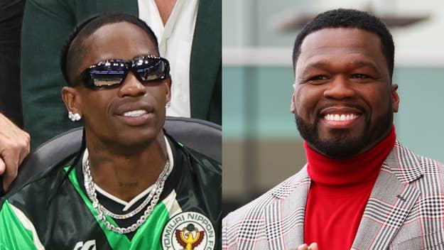 Travis Scott wearing a sports jersey and sunglasses smiles next to 50 Cent in a plaid suit and red turtleneck