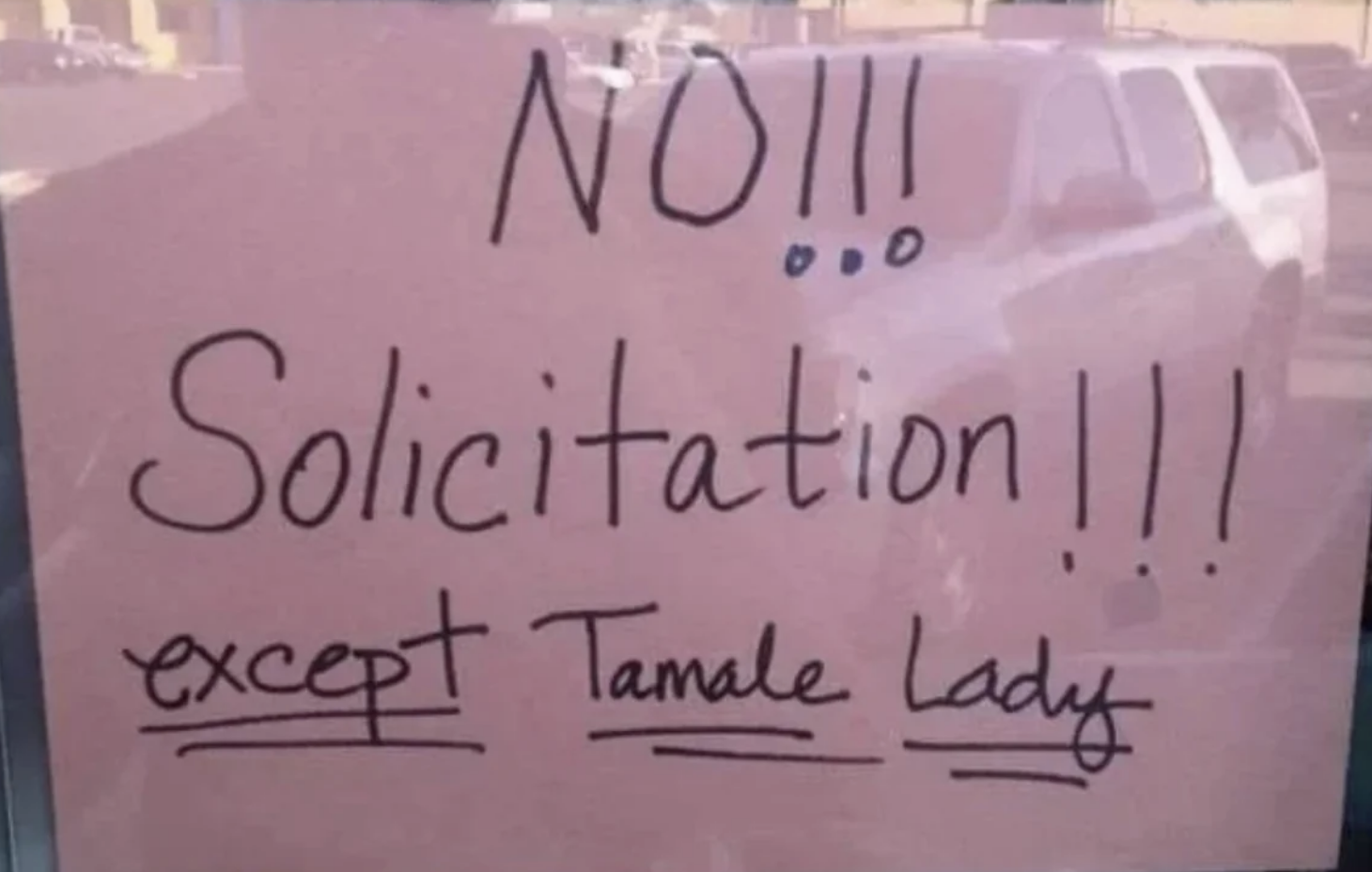 A handwritten sign on a door reads: "NO Solicitation!!! except Tamale Lady."