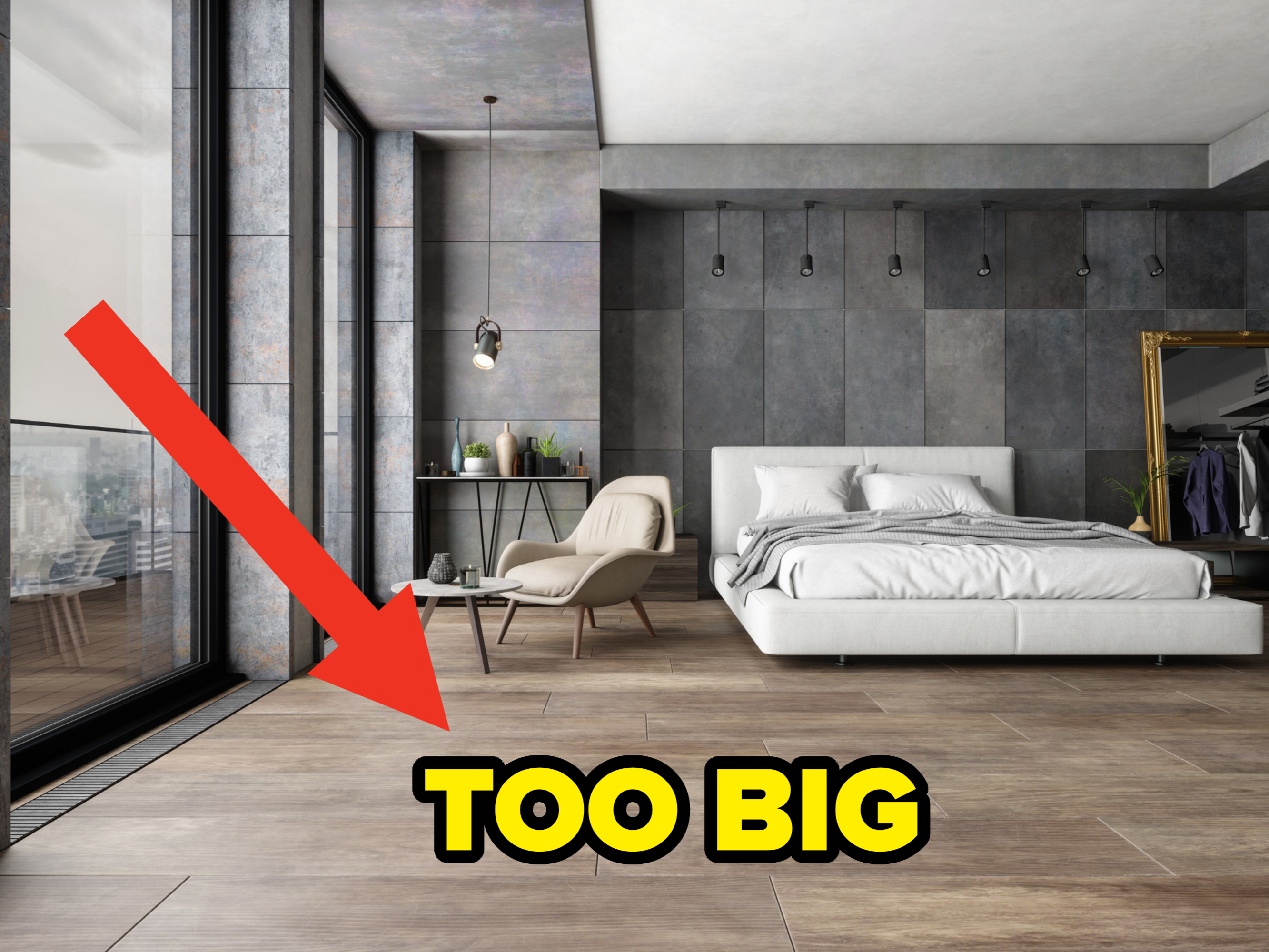 Modern bedroom with large windows, a white bed, and grey accent walls; there's a stylish reading chair with a side table and industrial pendant lights