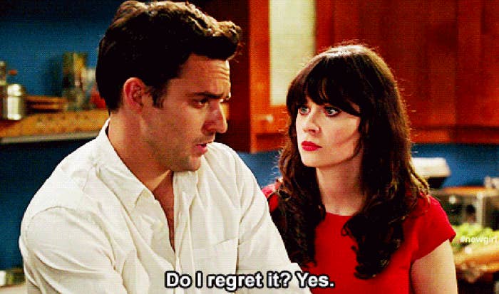 Jake Johnson and Zooey Deschanel in a kitchen, with Jake saying "Do I regret it? Yes." from the show "New Girl."