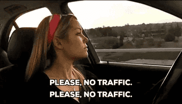 A woman wearing a headband is driving a car, glancing to the left. The text reads, &quot;PLEASE, NO TRAFFIC. PLEASE, NO TRAFFIC.&quot;