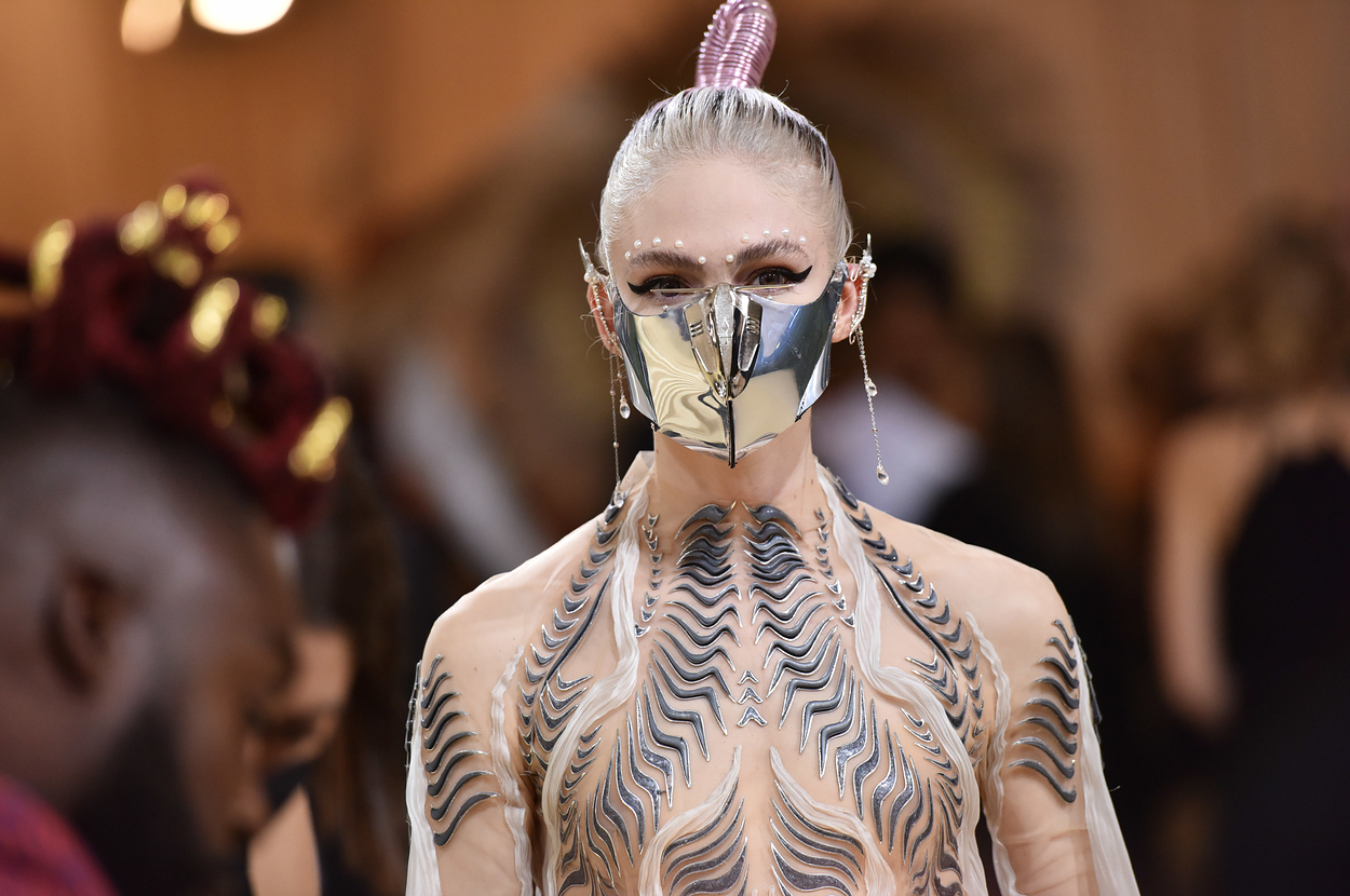 Grimes in a metallic outfit and matching mask at the Met Gala