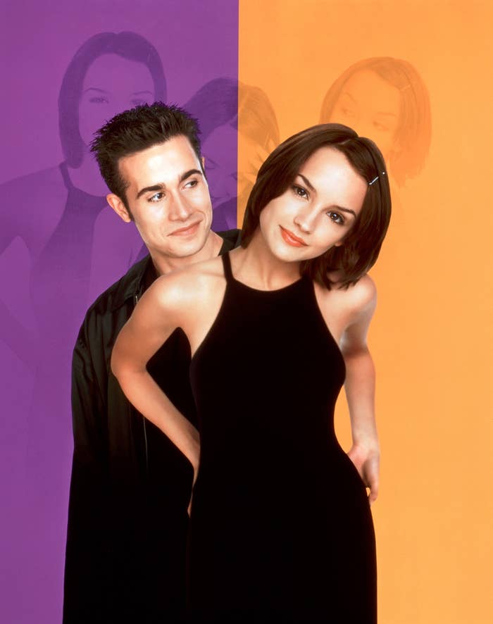 Freddie Prinze Jr. and Rachael Leigh Cook pose together; Freddie stands behind Rachael who's in a sleeveless dress. Both look towards the camera