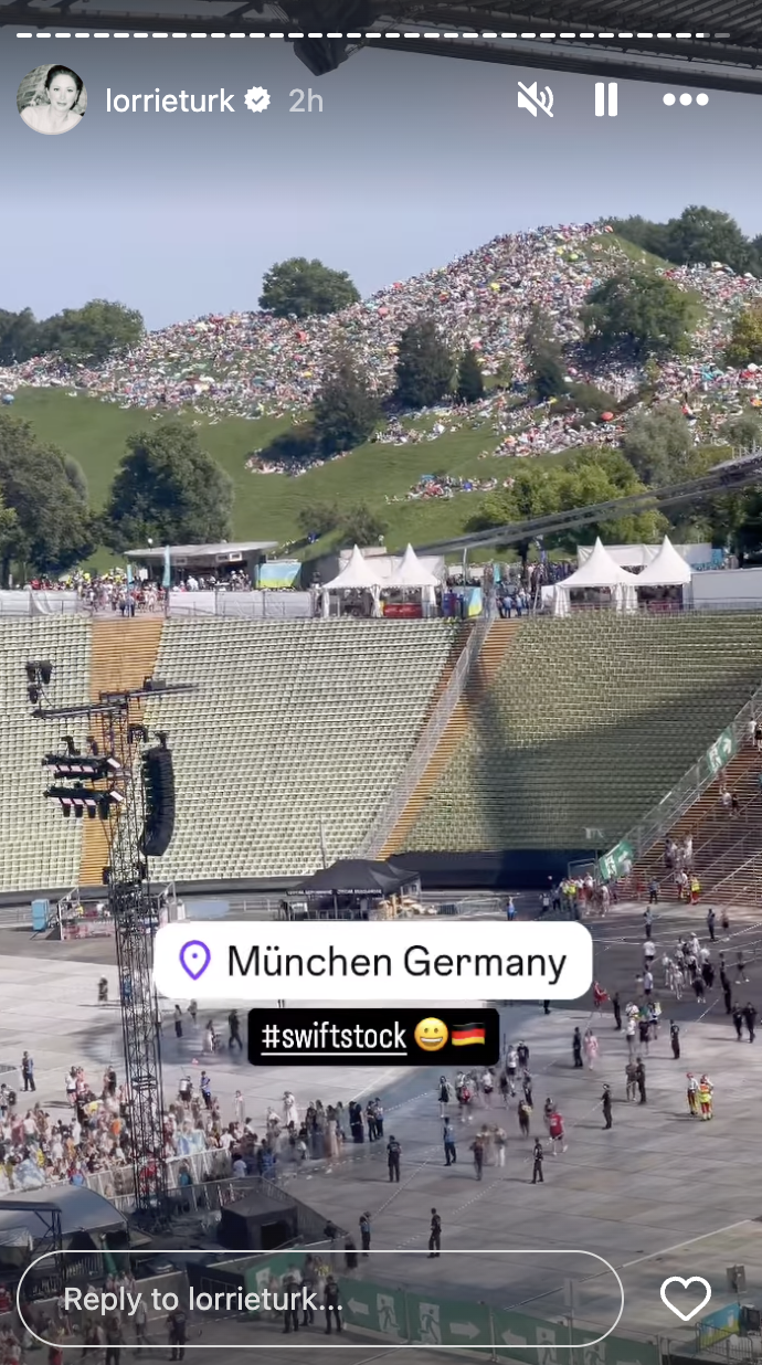 Large crowd gathered at outdoor venue in Munich, Germany, for #swiftstock event. Message reads: "München Germany #swiftstock" and includes excited emojis