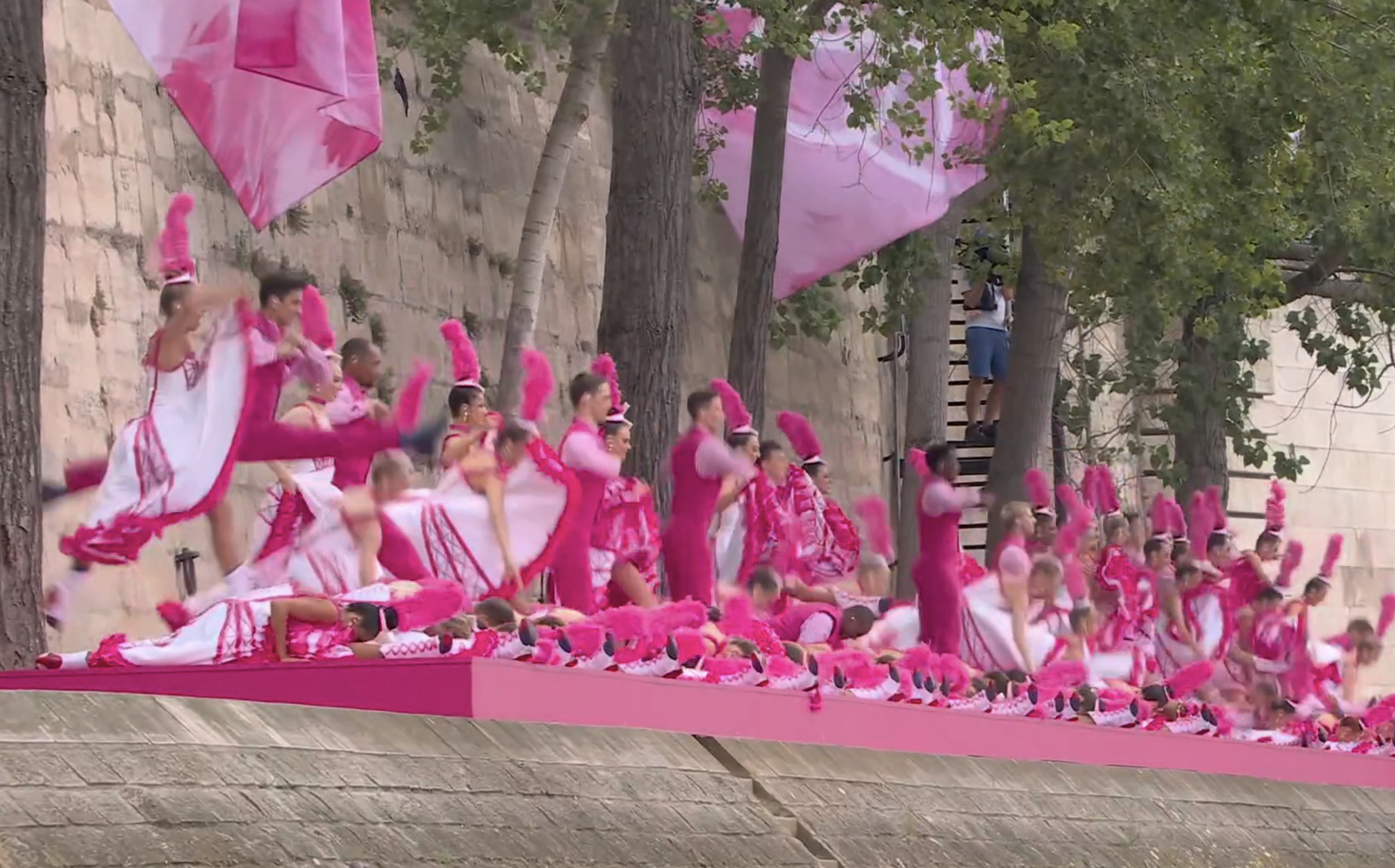 A sports team celebrates on a platform. They are wearing themed costume uniforms in a dynamic group display, accessorized with themed props