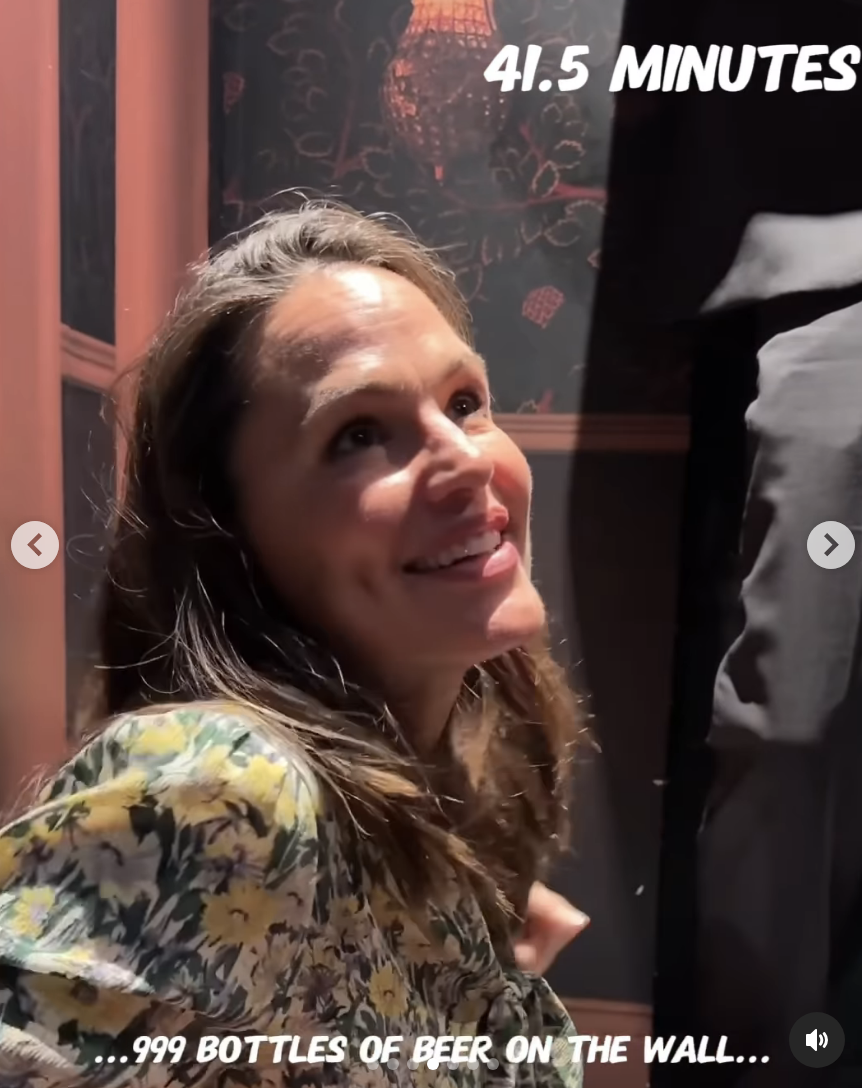 Jennifer Garner smiling, wearing a floral blouse. Around her, text reads &quot;41.5 MINUTES&quot; and &quot;999 Bottles of Beer on the Wall...&quot;