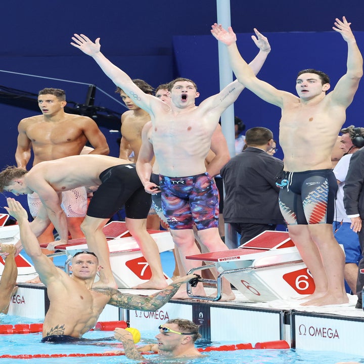 Michael Phelps, Caeleb Dressel, Ryan Murphy, and Nathan Adrian celebrate after their victory at a swim meet