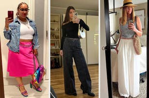 Three women taking mirror selfies: First woman in a denim jacket, white top, pink skirt, and colorful accessories. Second woman in a black long-sleeve top and wide-leg jeans. Third woman in a striped top, white wide-leg pants, and a wide-brimmed hat
