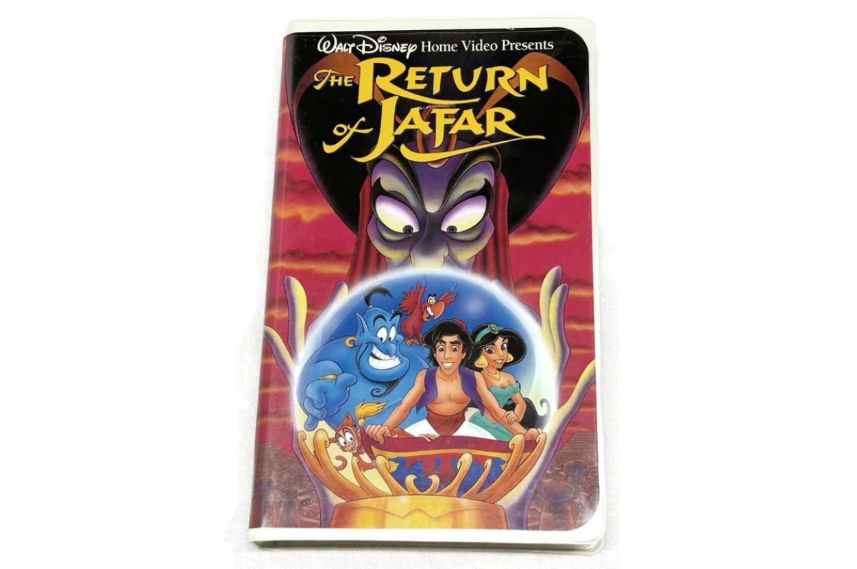 Walt Disney Home Video cover for "The Return of Jafar" featuring Genie, Aladdin, and Jasmine in a crystal ball with Jafar looming in the background