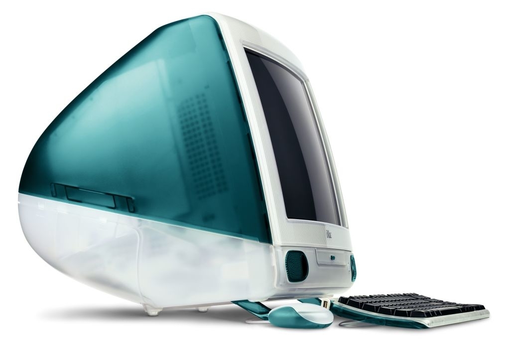 Vintage Apple iMac G3 desktop computer with a CRT monitor, teal accents, translucent housing, and accompanied by a matching keyboard and mouse