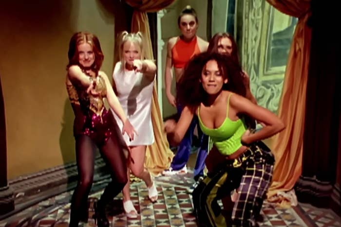 Geri Halliwell, Emma Bunton, Mel B, Victoria Beckham, and Mel C of the Spice Girls dancing in the Wannabe music video