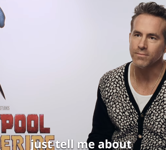 Ryan Reynolds in a patterned cardigan sits in an interview for &quot;Deadpool &amp;amp; Wolverine.&quot;