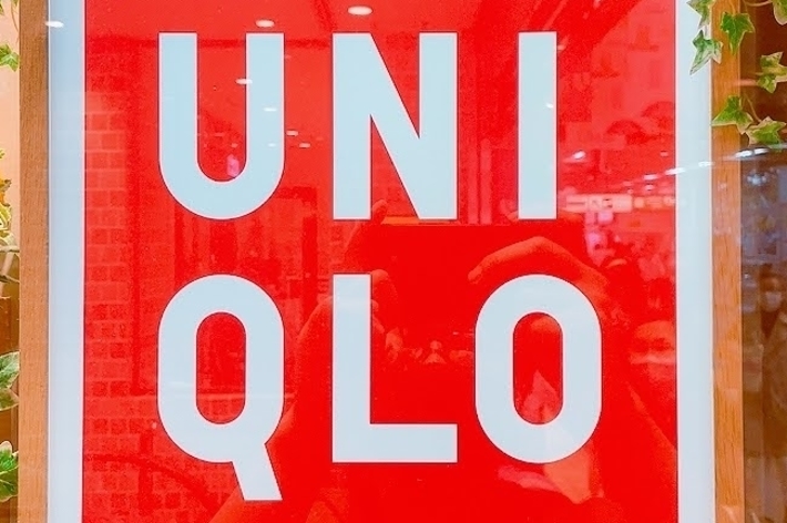 &ldquo;UNIQLO store sign decorated with flowers and greenery.&quot;