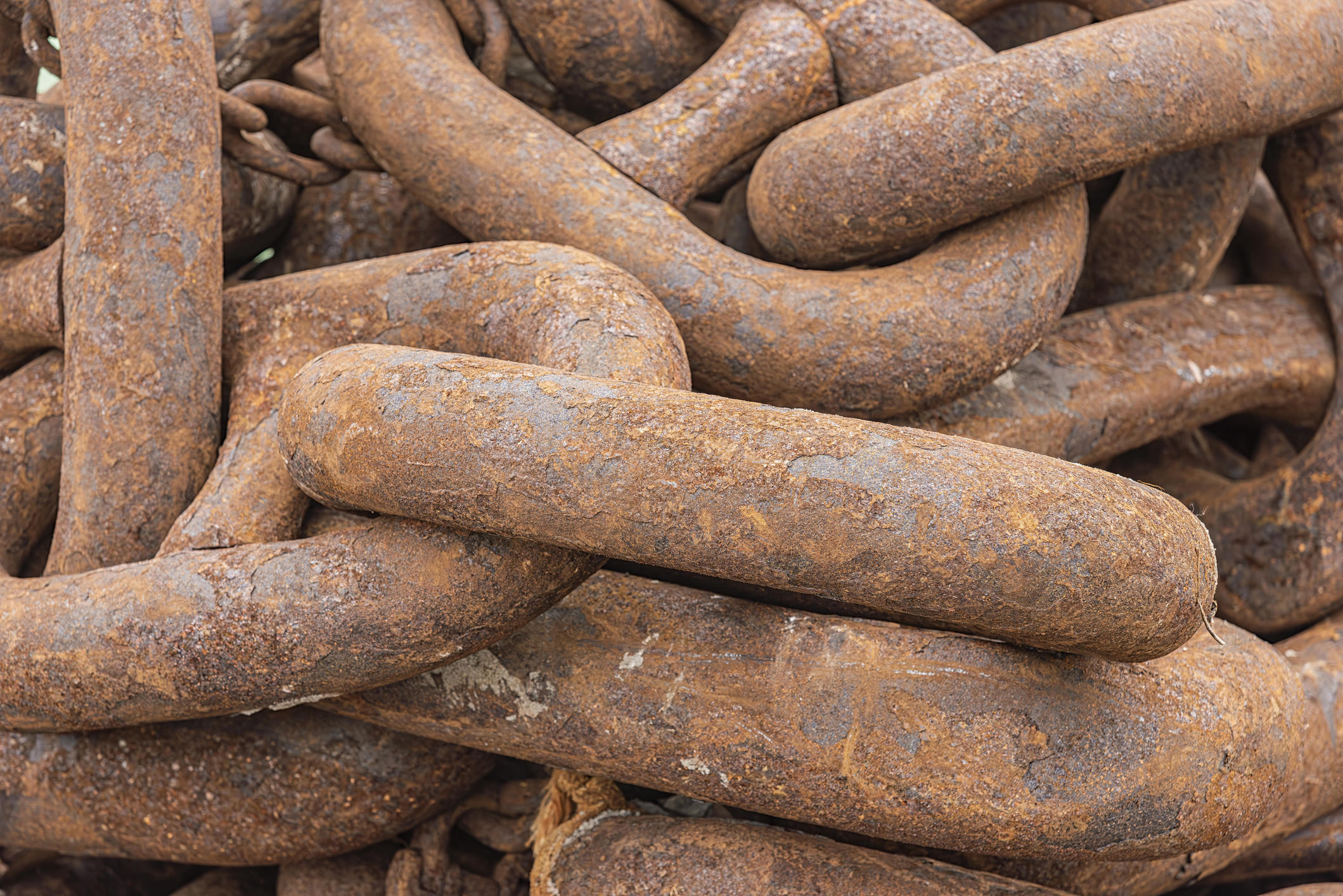 Rusty, interlocking metal chains in a close-up view