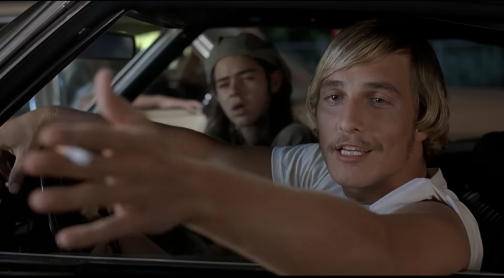 Matthew McConaughey and Rory Cochrane in a car, with McConaughey gesturing and talking