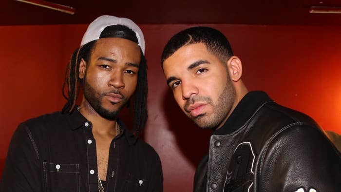 PARTYNEXTDOOR and Drake standing together, with PARTYNEXTDOOR wearing a hat and casual shirt, and Drake wearing a leather jacket