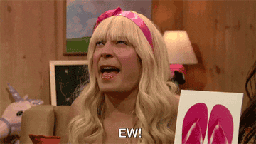 Jimmy Fallon dressed as a blonde-haired character making an "ew" face, holding a card with pink flip-flops. Text overlay reads: "EW!"