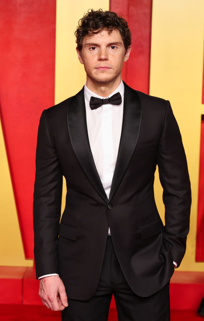 Evan Peters on the red carpet in a tuxedo with a bow tie