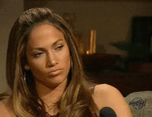 I don't know who is in this image. A person is seen raising an eyebrow and smirking slightly, giving a skeptical look during what appears to be an interview
