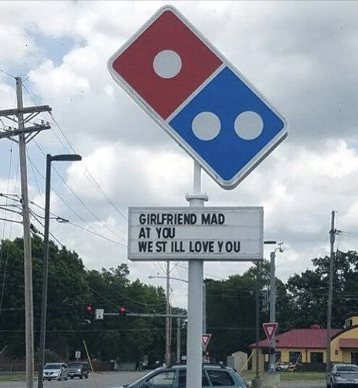 Domino's Pizza sign reads: "GIRLFRIEND MAD AT YOU, WE STILL LOVE YOU."