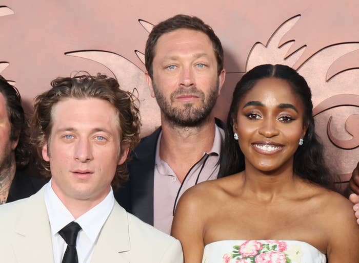 From left to right: Jeremy Allen White in a light-colored suit, Ebon Moss-Bachrach in casual suit and shirt, and Ayo Edebiri in a floral strapless dress