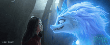 Raya smiles at Sisu, a dragon, from Disney's "Raya and the Last Dragon".