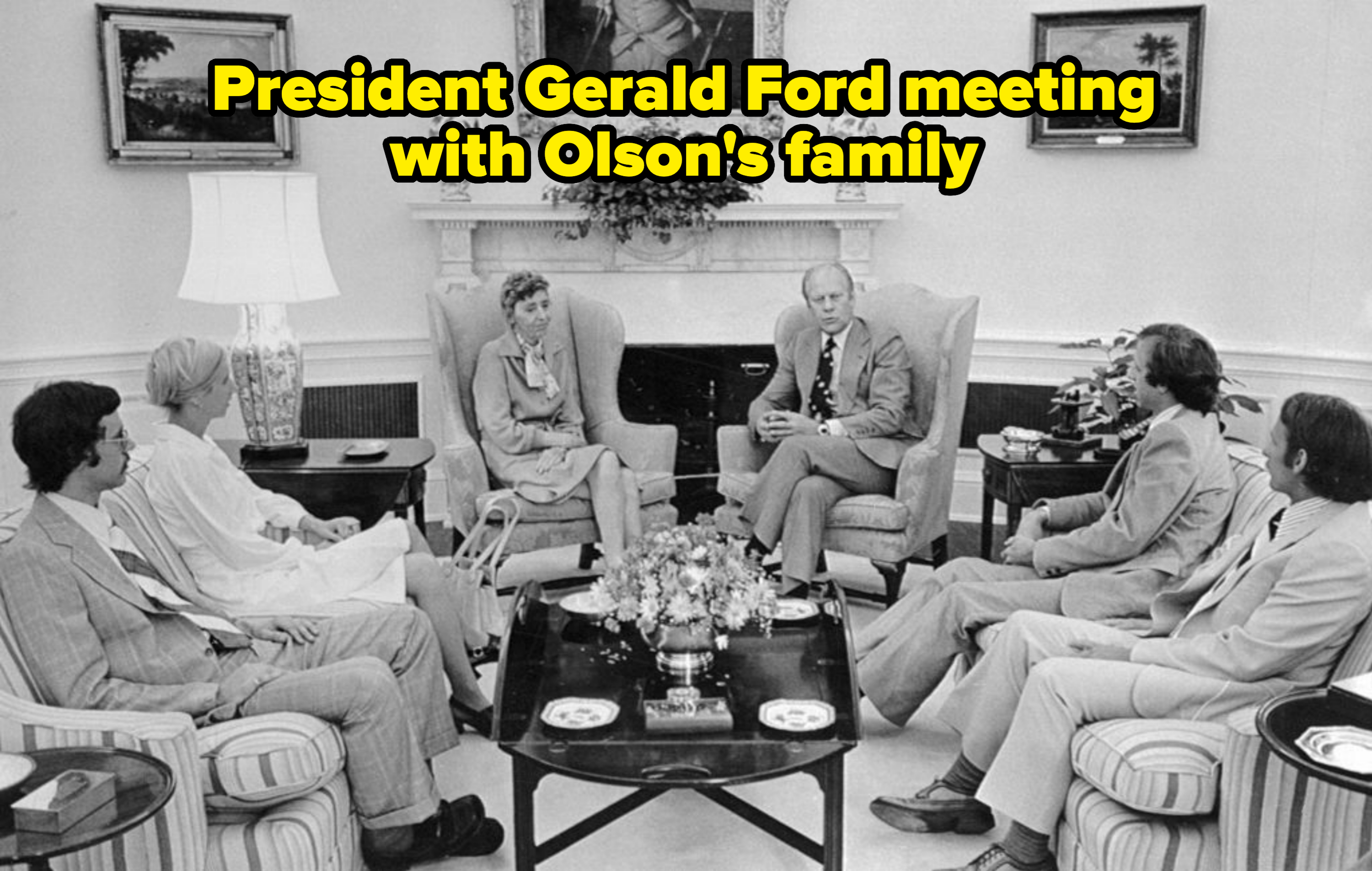 President Gerald Ford and First Lady Betty Ford sit with six unidentified individuals in a formal meeting room