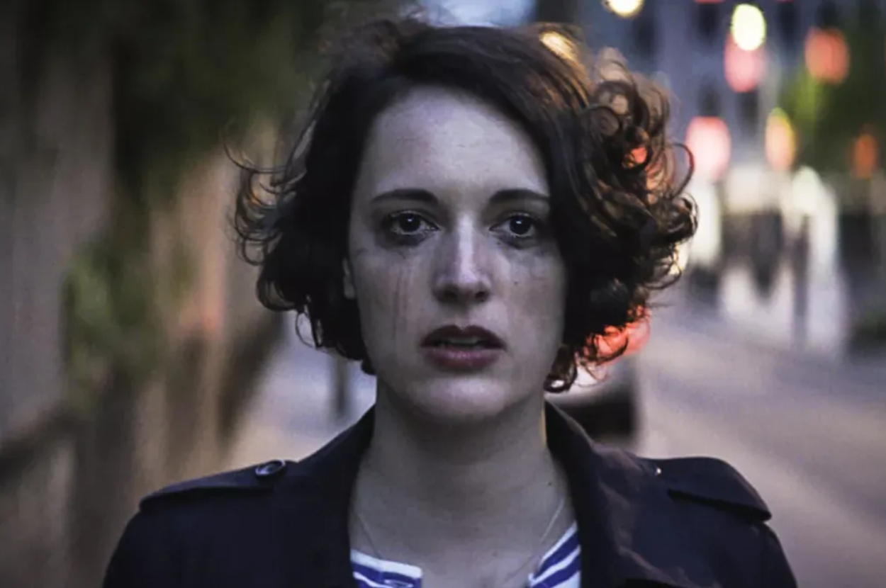 Phoebe Waller-Bridge with teary eyes and smeared mascara, staring ahead in a somber scene from "Fleabag."