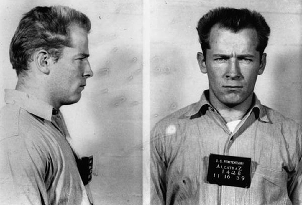 Two black-and-white mugshots of James "Whitey" Bulger from the front and side, dated 11-16-59, wearing a prison uniform