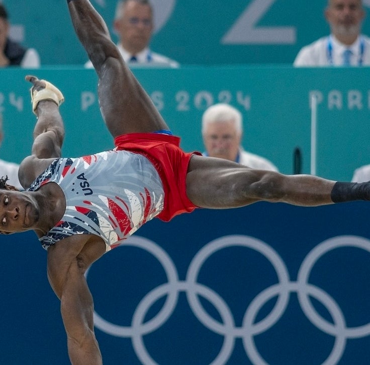 Gymnast performs a floor routine at Paris 2024 Olympics while judges watch