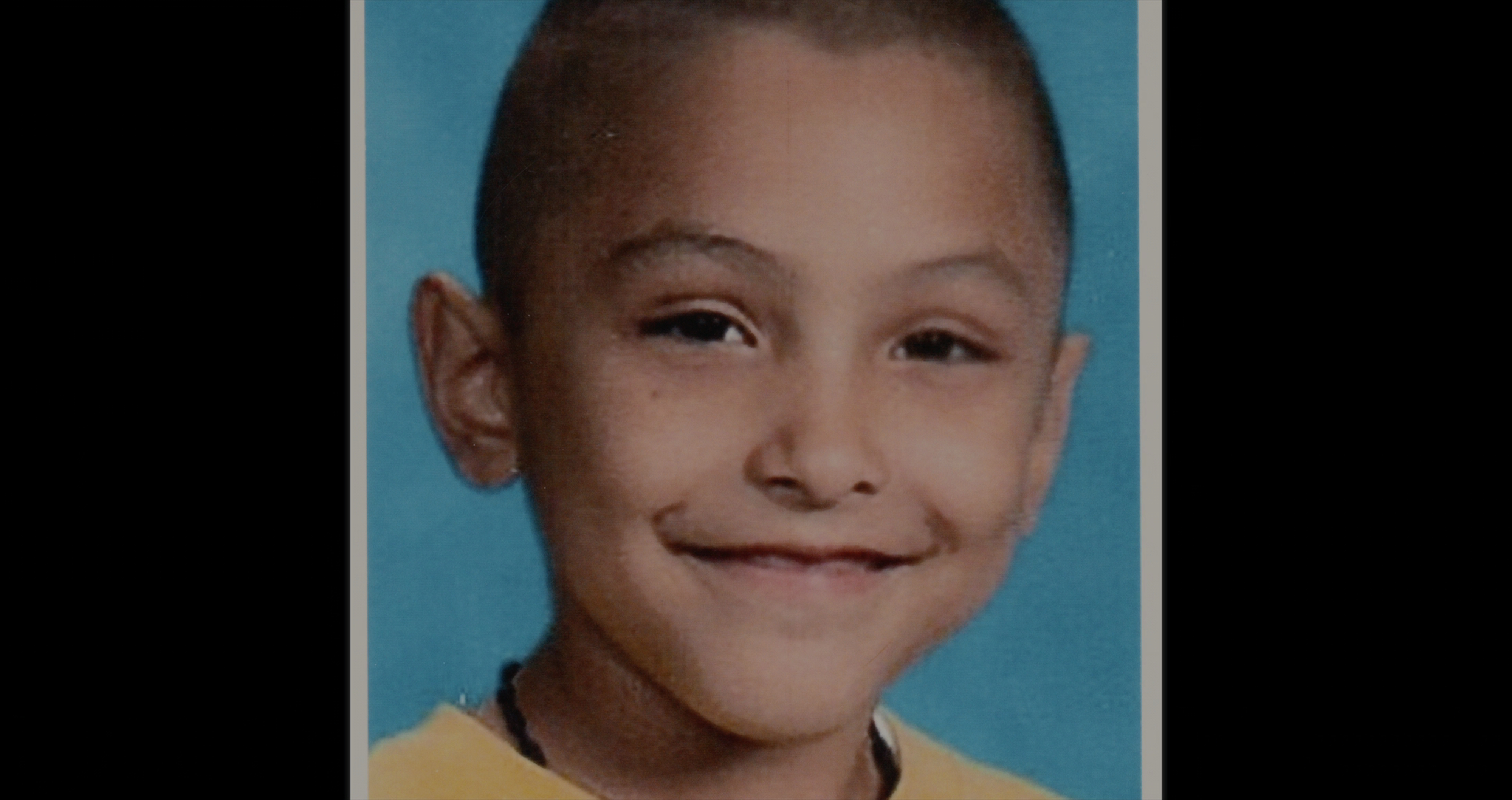 Gabriel Fernandez, with a shaved haircut is smiling at the camera
