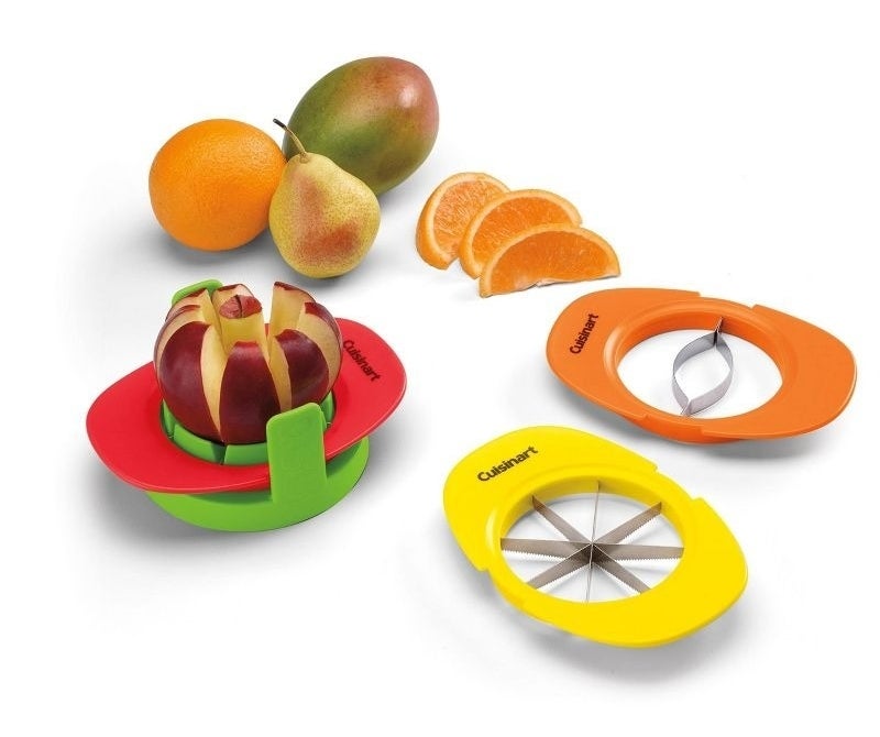 Fruit slicers and corers from Cuisinart displayed with an apple, orange, pear, and mango