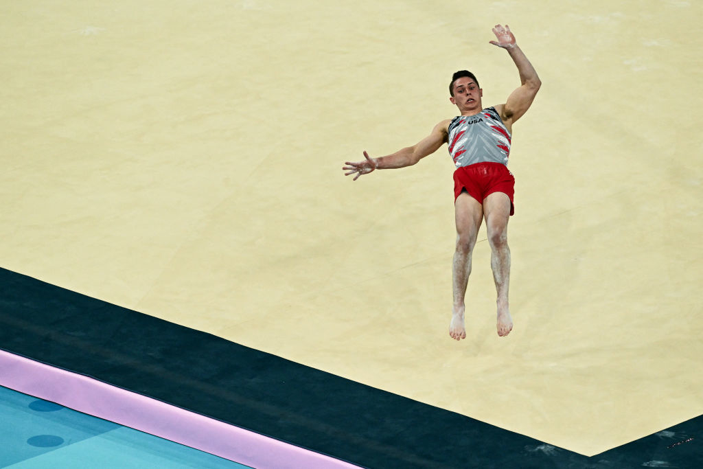 Gymnast leaping in mid-air during a floor routine