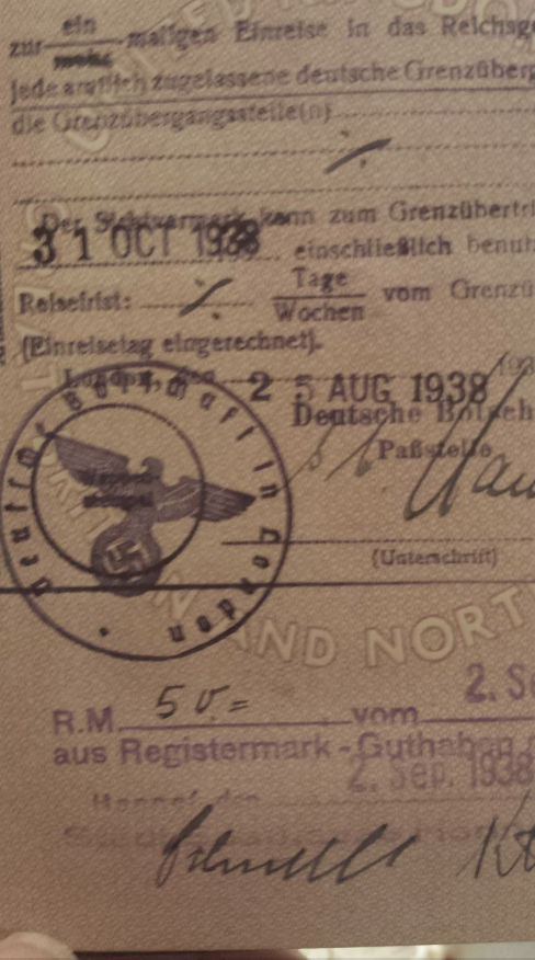 An old German travel document dated 31 Oct 1938 with a stamped Nazi eagle insignia and handwritten annotations